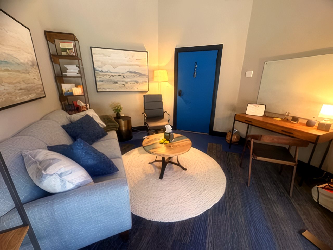 The counseling room with soft lamp light, writing desk, and cozy seating area